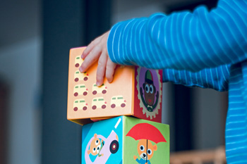 Child playing with colorful block toys