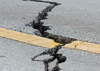 earthquake, large crack in road pavement