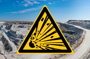 Explosives warning sign with background of stone quarry