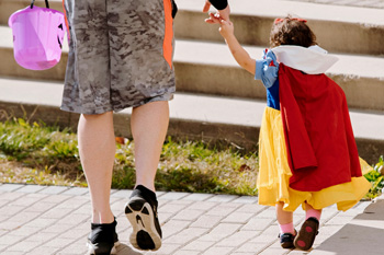 A little girl dressed up as Snow White for a Halloween costume