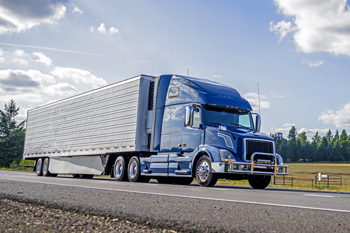 Semi truck driving down road