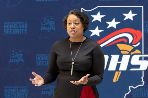 Secretary Green speaking in front of IDHS backdrop