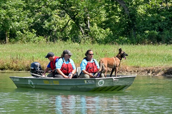 People on boat with dog