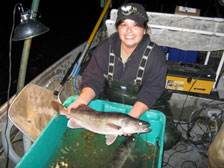 Fisheries biologist Debbie King holds a Monroe Lake walleye.