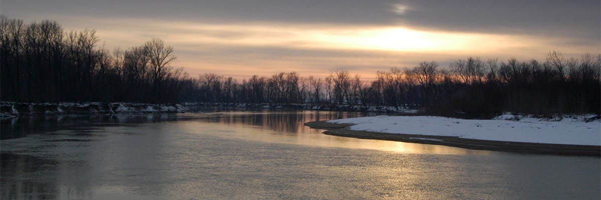 sun over river in winter