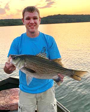 Man holding Hybrid Striped Bass at Monroe Lake