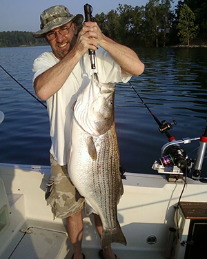 Jonathan VanHook of Rockville holds the state-record striped bass he caught May 25, 2010 at Cecil M. Harden Lake. 