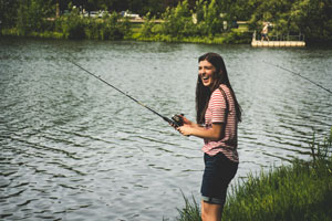 Women fishing on lake shore