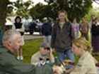 Biologist John Castrale checks an osprey chick's wing while other biologists look on. Photo by Alisha Schiffli.
