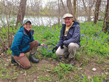 Liz Brownlee celebrates the acquisition of Lebline Woods for Oak Heritage Conservancy, a property known for its bluebells, with former property owner Steve Simmons.