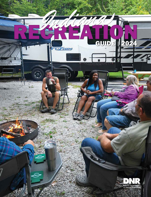 Cover of 2024 Recreation Guide showing people sitting around campfire