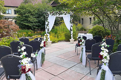 wedding arch and chairs in courtyard