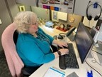 A person sitting at a desk using a computer  Description automatically generated with medium confidence