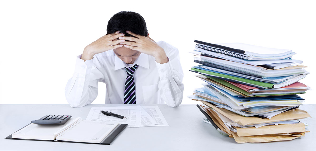 frustrated man with a pile of documents