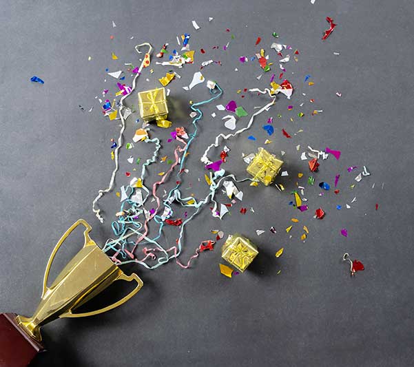Award with Confetti and Prizes on a Grey Background