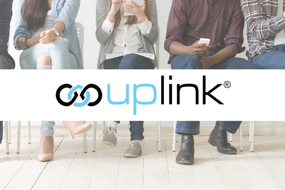 Uplink logo is on top overlaid on top of an image of people sitting in chairs using their phones