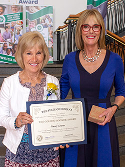 Picture of Nancy Conner receiving the award from the Lieutenant Governor
