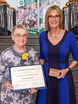 Picture of Marilyn Edmonds receiving the award from the Lieutenant Governor