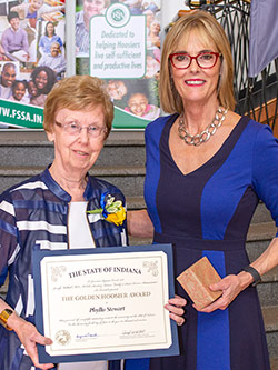 Picture of Phyllis Stewart receiving the award from the Lieutenant Governor