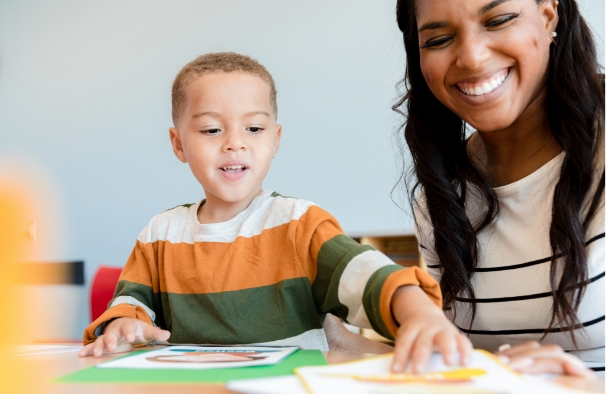 Woman playing game with young boy.