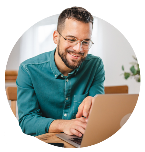 Man smiling while working at laptop.