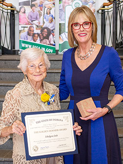 Picture of Joan Nash receiving the award for Ethylgene Josh from the Lieutenant Governor