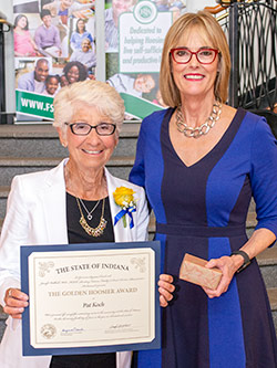 Picture of Pat Koch receiving the award from the Lieutenant Governor