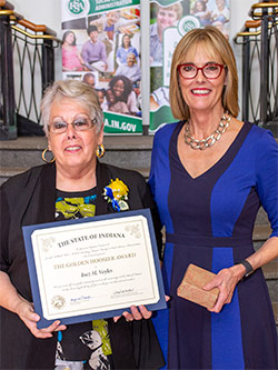 Picture of Inez Voyles receiving the award from the Lieutenant Governor