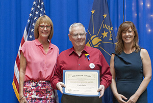 Photo of Frank Roales receiving the award