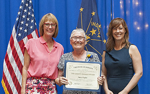 Photo of Nancy Hughes receiving the award