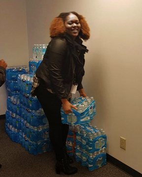 Image of employee picking up water