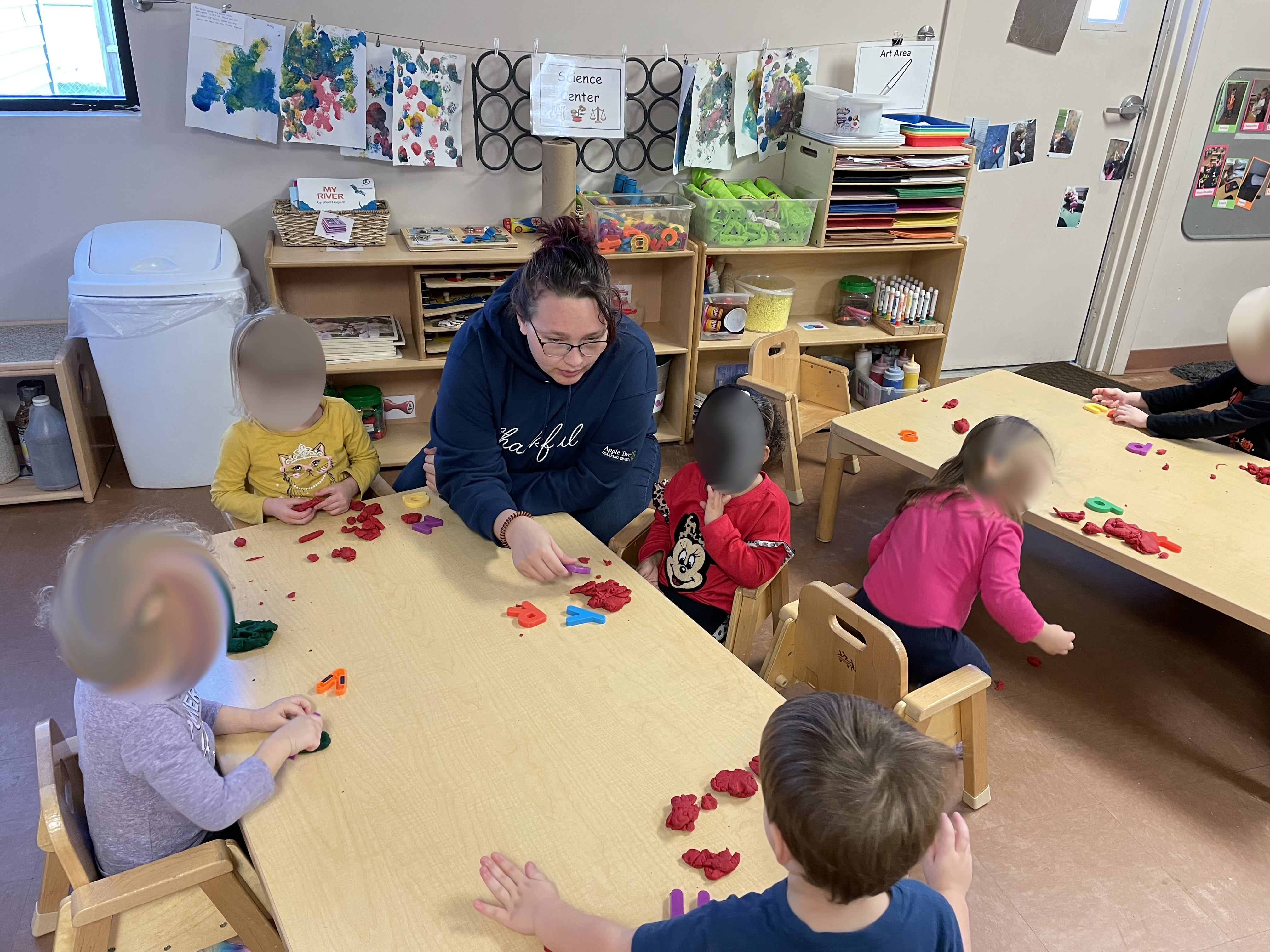 A child care worker engages with children.