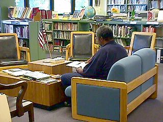 A patient sits in the library.