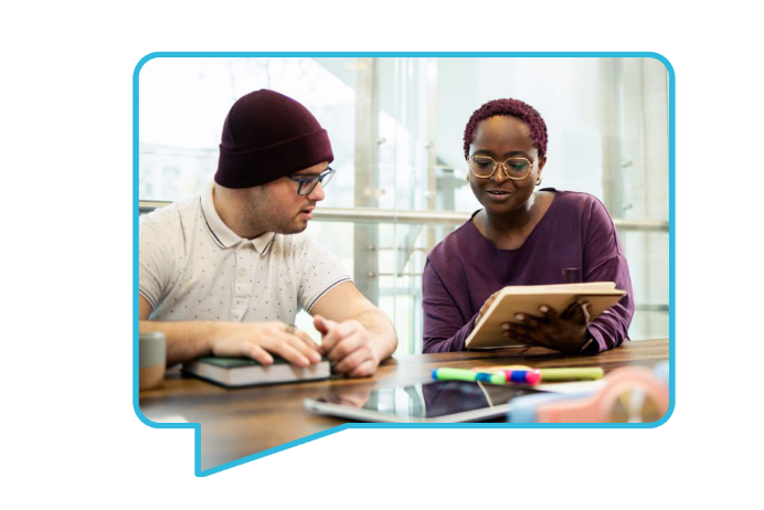 Man and woman reading a book together.