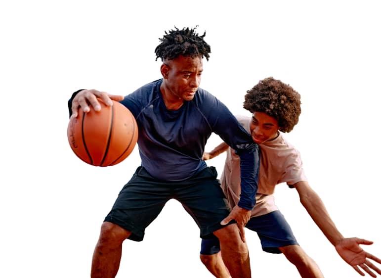 Two young men playing basketball.