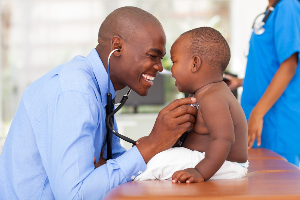 doctor using stethoscope on baby