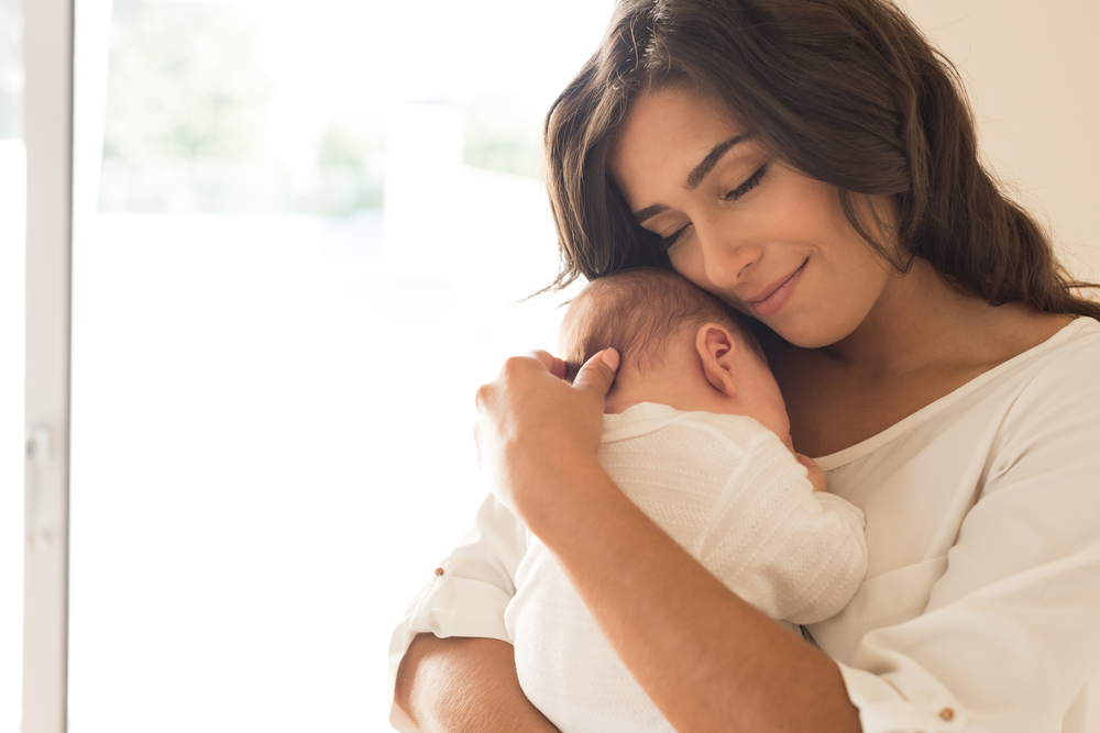 mom holding baby