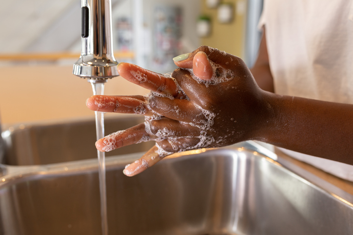 black woman washing hands