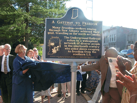 Pam Peters, the marker applicant, on left and Rev. Anthony Toran, Director of City Operations, New Albany, unveiling the marker.