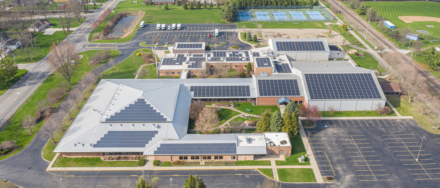 image of a school with solar panels on the roof