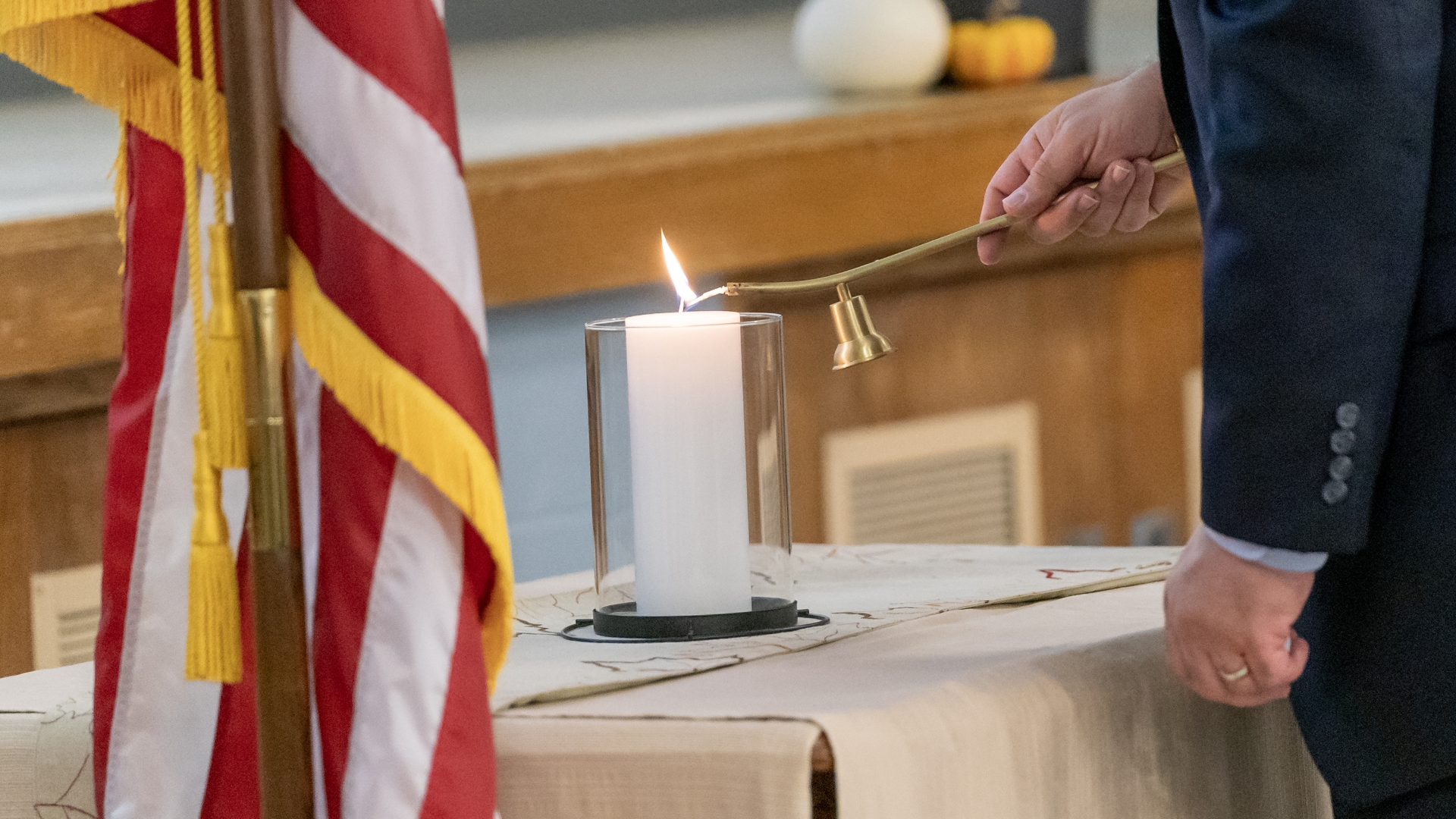 Lighting a candle in honor of those who gave their life to IDOC