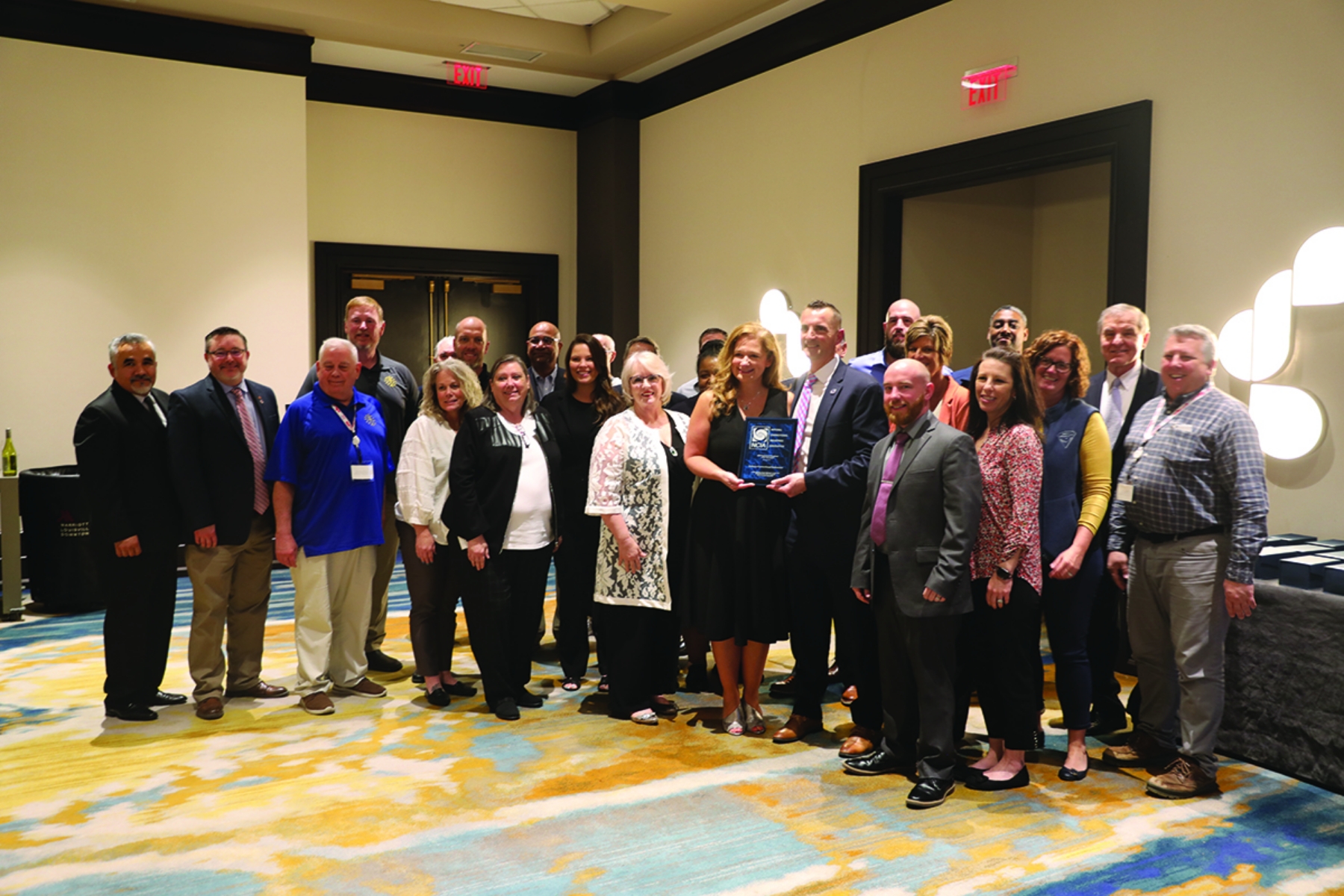 Staff of the Indiana Correctional Industries posing with the NCIA Performance Excellence Award.