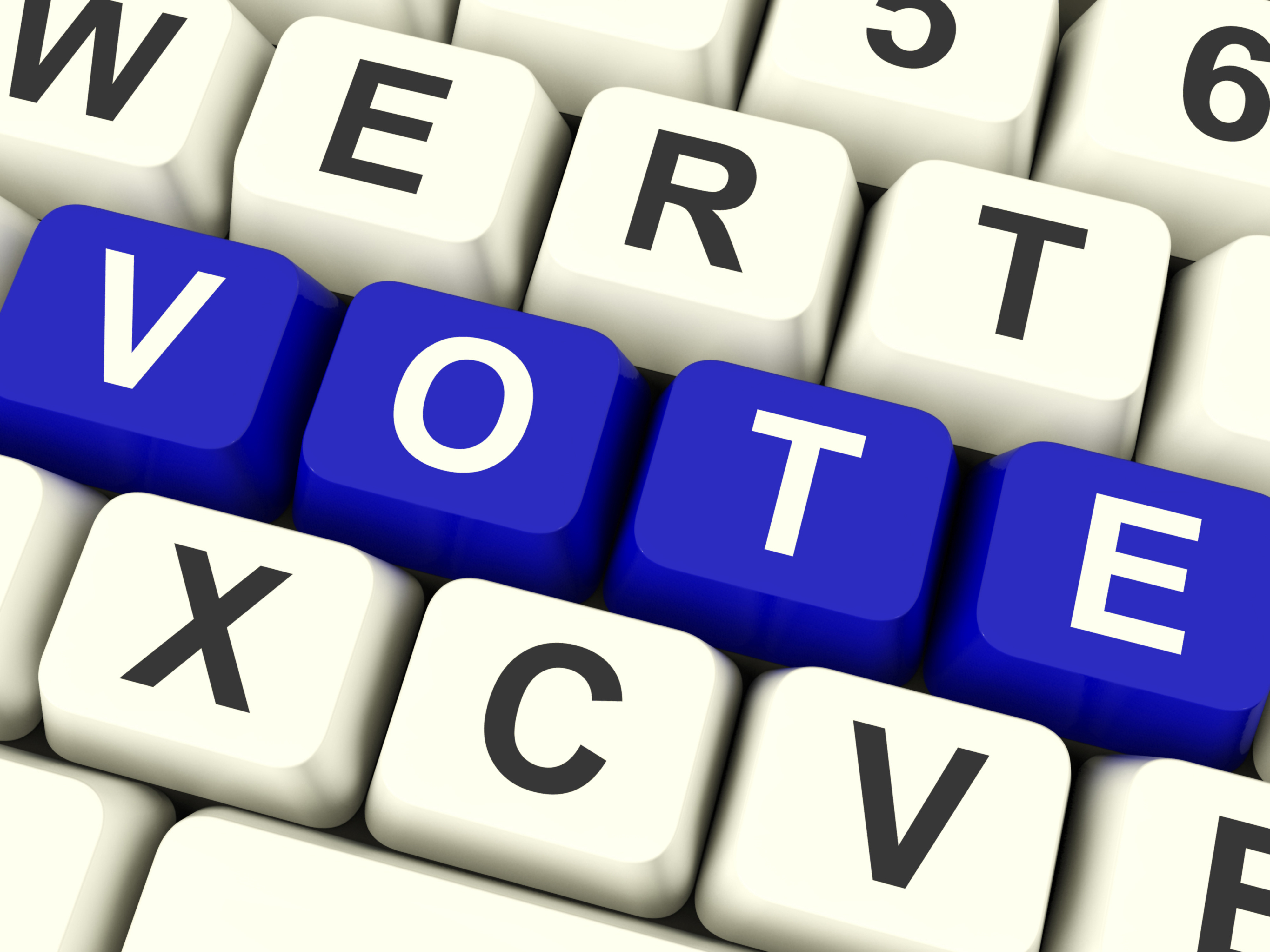 A keyboard with the letters on the second row rearranged to read “VOTE.” S. The “vote” keys are blue with white text and the surrounding keys are white with black text. 