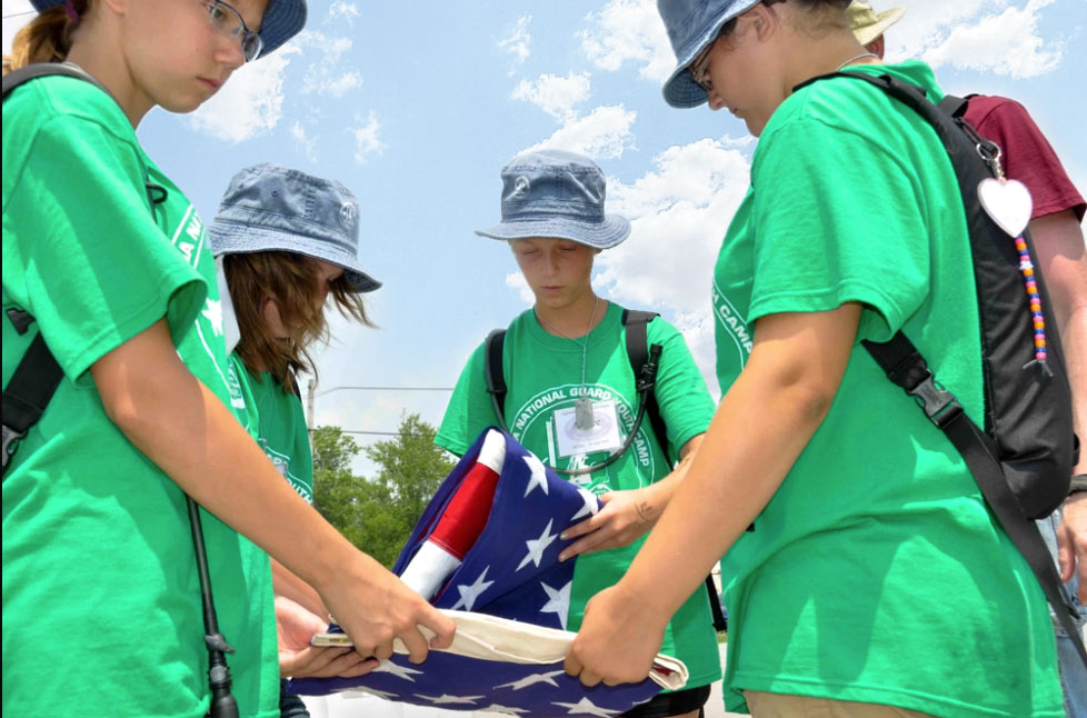 Kids folding the American Flag at Kids AT Summer Youth Camp