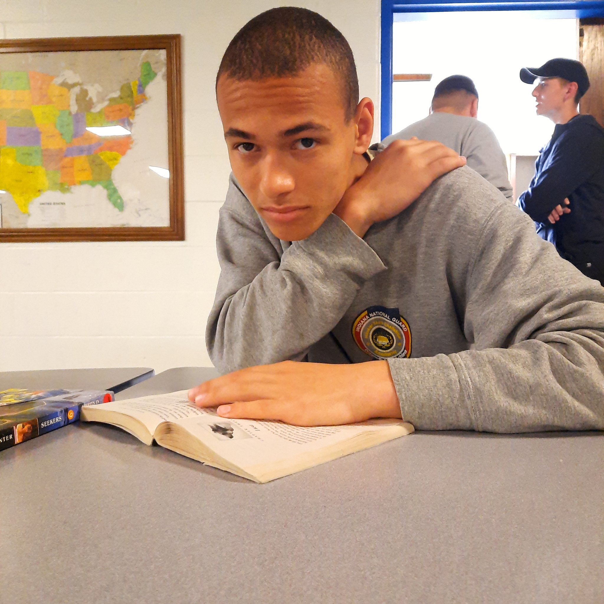 HYCA Cadet reads book in cafeteria