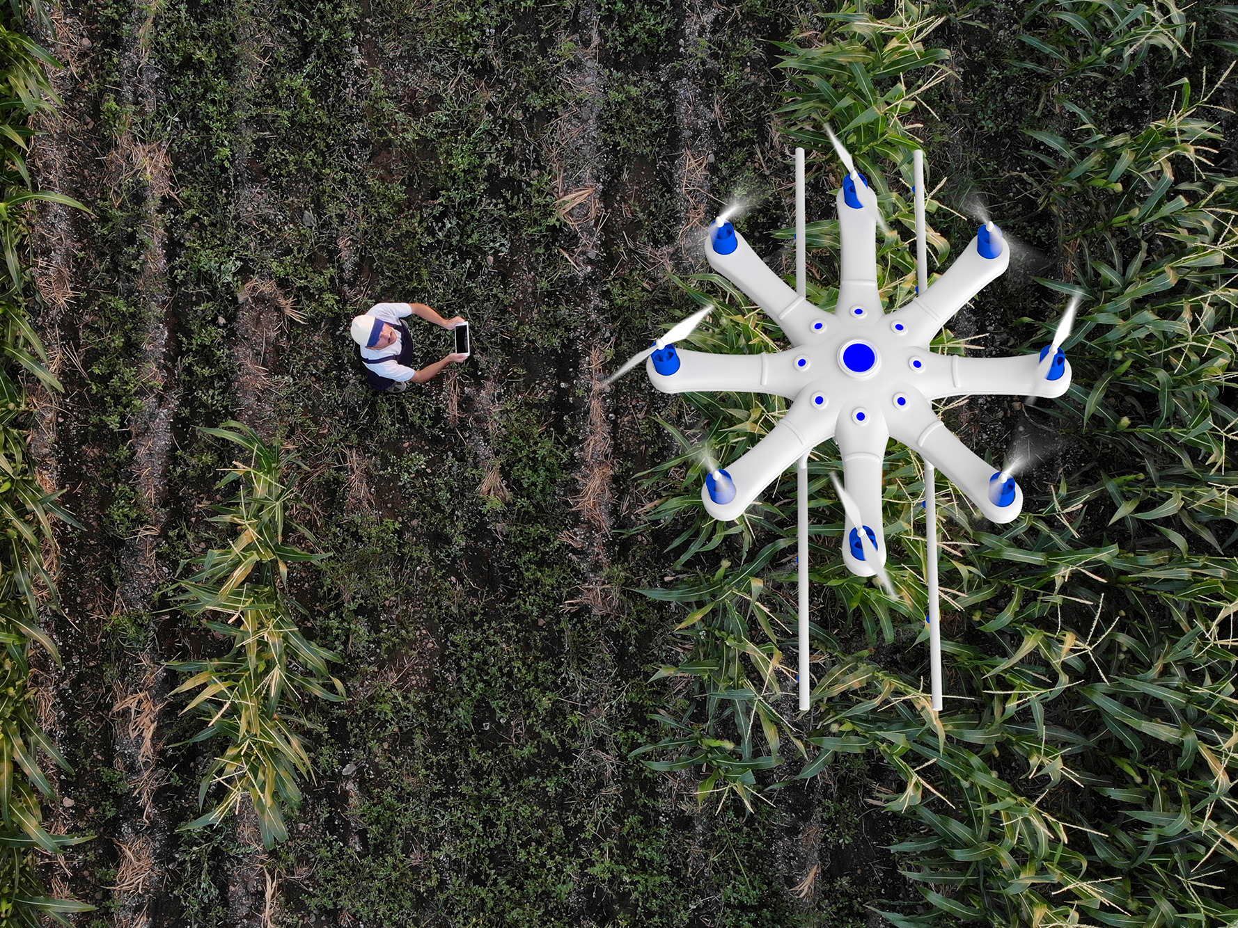 Man in a rural field flying a drone