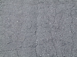 Photo showing fine longitudinal hairline cracks                 running parallel to one another with only a few interconnecting cracks. The cracks are not spalled.