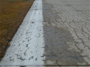 Overview photo of a PCC slab with a noticeable pattern of spalled cracks spread over the entire surface area of the slab.