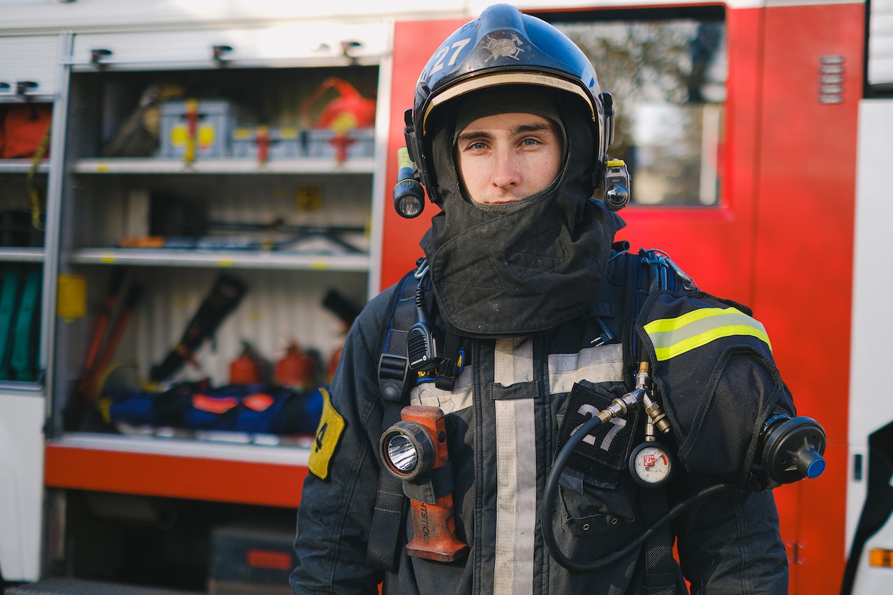 young male firefighter posing in uniform