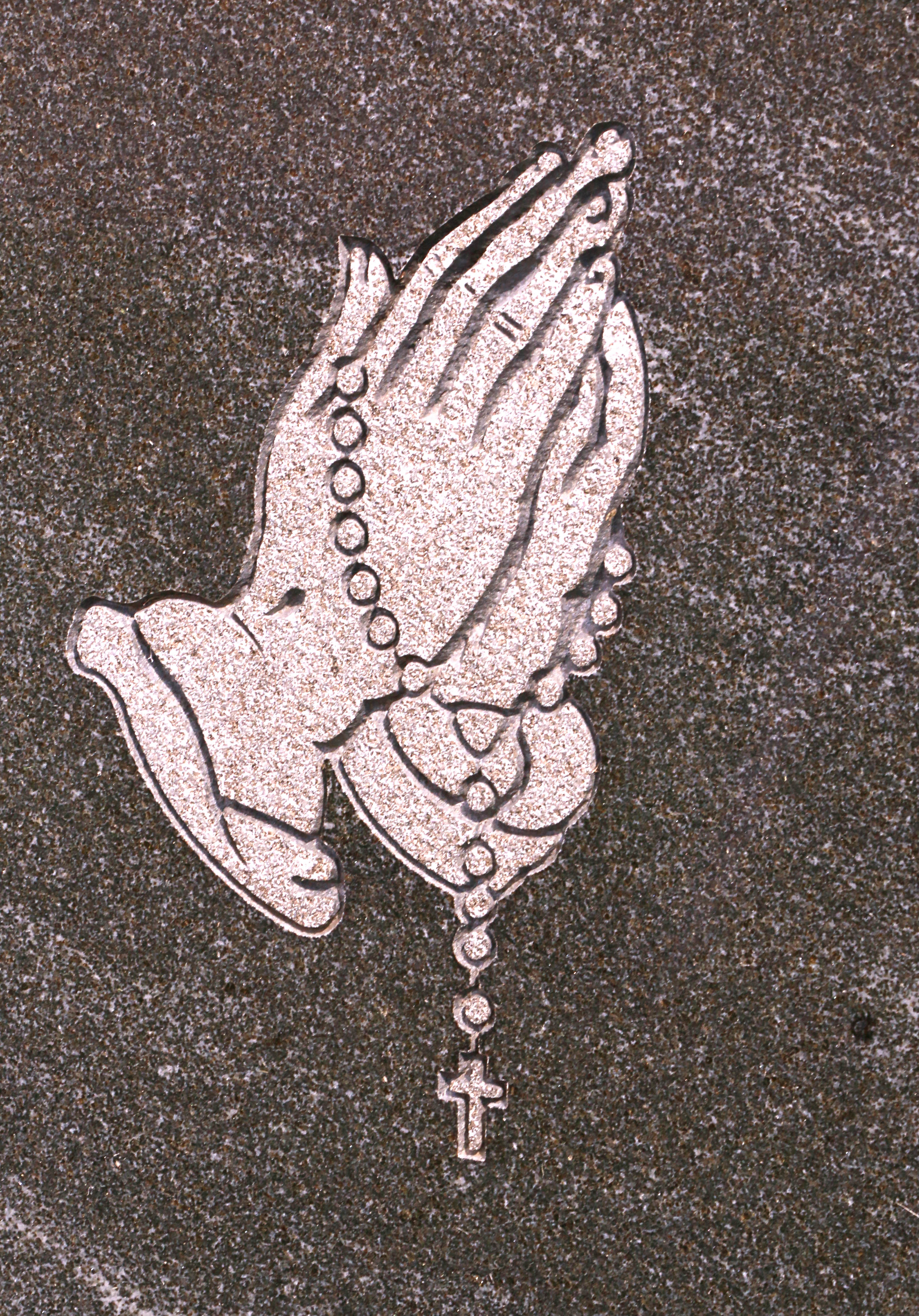 Headstone close-up - praying hands